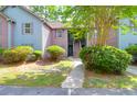 Charming multi-story condo with well-maintained landscaping, including mature trees and sculpted bushes at 7911 Windfern Ct # 1502, North Charleston, SC 29418