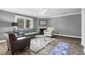 Bright living room with hardwood floors, a comfortable sofa, and a decorative fireplace with a mirror at 7911 Windfern Ct # 1502, North Charleston, SC 29418