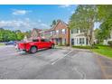 Street view of townhomes with a red truck in the foreground and visible unit numbers at 811 Reserve Way, Summerville, SC 29485