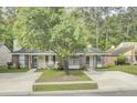 Charming single-story home featuring brick accents, a welcoming front porch, and a well-maintained lawn with mature trees at 815 Temple Rd # B, Ladson, SC 29456