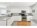 Bright kitchen featuring white cabinets, stainless steel appliances, and granite countertops at 9 Fairway Dunes Ln, Isle of Palms, SC 29451