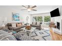 Comfortable living room featuring stylish furnishings, fireplace, and sliding doors to outdoor deck at 9 Fairway Dunes Ln, Isle of Palms, SC 29451
