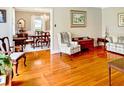 Elegant living room showcasing hardwood floors, traditional furnishings, and a seamless flow into the dining area at 104 Bryant St, Saint George, SC 29477