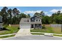 Two-story home with a two car garage and inviting front porch located on a manicured lot at 107 Belgian Ct, Summerville, SC 29486