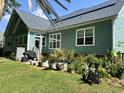 Backyard features a well-maintained lawn, a variety of plants, and a patio area at 1207 Rivers Reach Dr, Wando, SC 29492