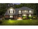 Charming two-story home with brick and siding exterior, lush landscaping, and a well-maintained lawn at dusk at 122 Hidden Fawn Cir, Goose Creek, SC 29445