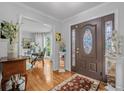 Elegant foyer with hardwood floors, decorative rug, and stained glass door, offering a grand entrance at 122 Hidden Fawn Cir, Goose Creek, SC 29445