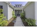 Inviting front entrance with lush landscaping and a pathway leading to the double-door entry at 1245 Hammrick Ln, Johns Island, SC 29455