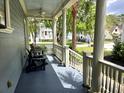 Relaxing covered porch featuring comfortable seating and scenic neighborhood views at 133 Wando Reach Rd, Wando, SC 29492