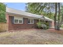 Charming brick home with lush landscaping and well-manicured lawn at 1534 Salisbury St, Charleston, SC 29407