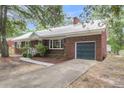 Traditional brick home with attached garage, well-maintained lawn, and concrete walkway at 1534 Salisbury St, Charleston, SC 29407