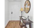 Hallway boasts hardwood floors, a console table, decorative mirror, and neutral paint tones at 157 Tyger St, Summerville, SC 29485