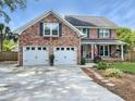 Attractive brick home with a two-car garage and a beautifully landscaped front yard at 16 Charlyn Dr, Charleston, SC 29407