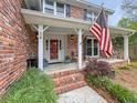 Inviting front porch featuring a comfortable seating area and charming curb appeal at 16 Charlyn Dr, Charleston, SC 29407