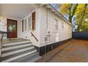 Charming cottage-style home featuring white siding, wooden shutters, and a quaint front porch with inviting steps at 177 Spring St, Charleston, SC 29403