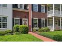 Inviting brick home with black shutters, a welcoming front door, and lush landscaping at 1781 Tennyson # 6, Mount Pleasant, SC 29466