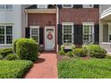 Charming home featuring a bright door with a wreath, surrounded by lush landscaping and black shutters at 1781 Tennyson # 6, Mount Pleasant, SC 29466