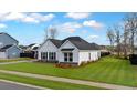 Well-maintained home featuring a lush green lawn, complemented by sleek black accents and a tidy landscape at 179 Darby Meadow Ln, Ridgeville, SC 29472