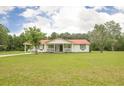 Charming home featuring a cozy front porch, complemented by a vast, well-maintained green lawn at 201 Welles Ln, Walterboro, SC 29488