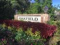 Oakfield community entrance sign is framed by colorful landscaping and decorative lanterns at 2022 Elvington Rd, Johns Island, SC 29455
