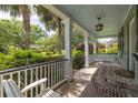 Relaxing covered porch with swing seating, offering a tranquil outdoor space at 2050 Wappoo Hall Rd, Charleston, SC 29412