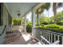 Inviting front porch with cozy swing, providing a relaxing outdoor retreat at 2050 Wappoo Hall Rd, Charleston, SC 29412