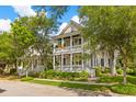 Beautiful two-story home featuring double porches and landscaping at 225 Delahow St, Daniel Island, SC 29492