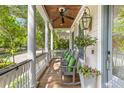 Inviting front porch with classic columns and comfortable rocking chairs at 225 Delahow St, Daniel Island, SC 29492