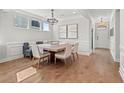 Elegant dining room featuring hardwood floors, wainscoting, and modern chandelier lighting at 238 Silk Oak Dr, Moncks Corner, SC 29461
