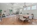 Bright, open-concept living room and dining area with hardwood floors and a cozy fireplace at 238 Silk Oak Dr, Moncks Corner, SC 29461