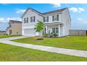 Beautiful two-story home featuring a manicured lawn and an attached two-car garage at 306 Lucca Dr, Summerville, SC 29486