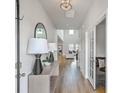 Bright hallway with hardwood floors, modern decor, and a view into the living area at 306 Lucca Dr, Summerville, SC 29486