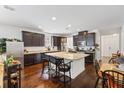 Well-lit kitchen with a large island, granite countertops, and sleek dark cabinets at 3121 Harding Ct, Johns Island, SC 29455