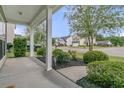 Covered front porch view highlighting meticulous landscaping and neighborhood street at 3537 Galaxy Rd, Ladson, SC 29456