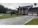 Traditional brick home boasting a spacious driveway and attached two-car garage at 36 Forde Row, Charleston, SC 29412