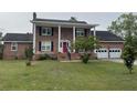 Charming two-story brick home featuring a bright red front door and a lush green lawn at 36 Forde Row, Charleston, SC 29412