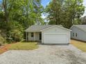 Charming single-story home featuring a one-car garage and gravel driveway at 4013 A Ladson Rd, Ladson, SC 29456