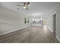 Open-concept living room and kitchen area with modern gray flooring and natural light at 4013 A Ladson Rd, Ladson, SC 29456