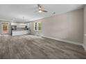 Open-concept living room with gray flooring, modern lighting, and an adjacent white kitchen at 4013 B Ladson Rd, Ladson, SC 29456