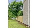 Fenced backyard with a lake view and fountain, next to the house's siding at 4114 Babbitt St, Charleston, SC 29414