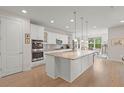 Modern kitchen with white cabinets, granite countertops, and stainless steel appliances at 423 Four Seasons Blvd, Summerville, SC 29486
