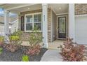 Inviting front porch with stylish details and well-maintained landscaping at 431 Canal Crossing Way, Huger, SC 29450