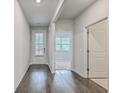 Bright hallway with hardwood floors leads to various rooms in the home at 431 Canal Crossing Way, Huger, SC 29450