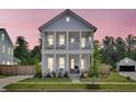 Charming two-story home featuring a double porch and meticulously landscaped yard at 435 Woodgate Way, Summerville, SC 29485