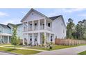 Charming two-story home featuring a double porch, meticulously landscaped yard, and a welcoming driveway at 435 Woodgate Way, Summerville, SC 29485