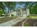 View of the home showing the driveway and a neatly landscaped yard with fresh mulch at 5088 Thornton Dr, Summerville, SC 29485