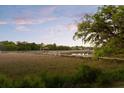 Picturesque marsh view with a dock, gazebo, and boat lift at 554 Parrot Point Dr, Charleston, SC 29412