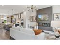 Bright living room with a modern fireplace and an open view of the kitchen at 566 Scholar Way, Summerville, SC 29486