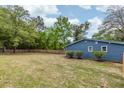 Large backyard with a wooden fence, grass, and plenty of room to play at 6146 Chisolm Rd, Johns Island, SC 29455
