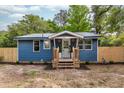 Charming blue home with a metal roof and newly landscaped flower beds at 6146 Chisolm Rd, Johns Island, SC 29455